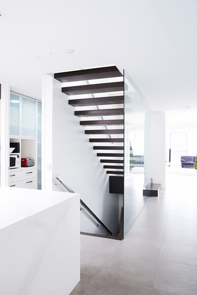 Inspiration for a mid-sized contemporary wood floating staircase in Melbourne with open risers.