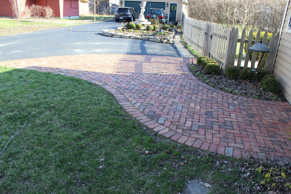 This is an example of a large traditional backyard patio in Indianapolis with natural stone pavers.