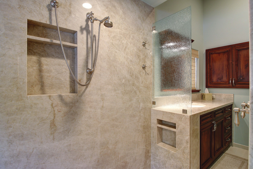 Mid-sized traditional master bathroom in Santa Barbara with a curbless shower, green walls, an undermount sink, quartzite benchtops, beige tile, porcelain floors, dark wood cabinets, recessed-panel cabinets and beige floor.