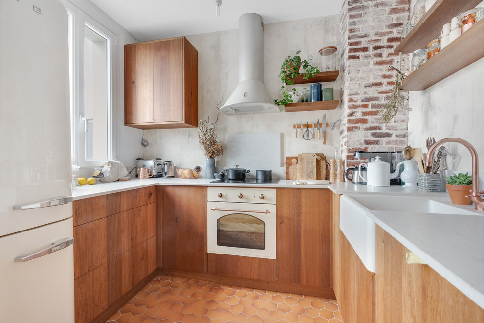 Design ideas for a mid-sized scandinavian u-shaped kitchen in Paris with quartzite benchtops, grey splashback, terra-cotta floors, orange floor, white benchtop, flat-panel cabinets, medium wood cabinets, no island, a farmhouse sink and white appliances.