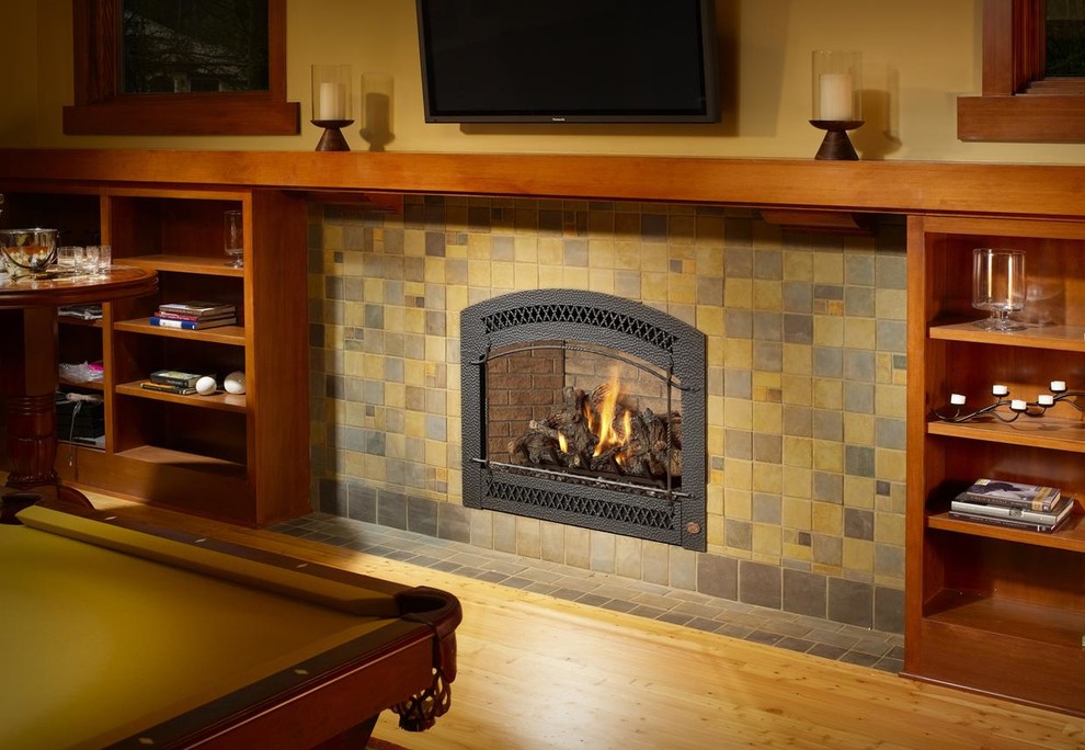 Large arts and crafts enclosed family room in Seattle with a game room, yellow walls, light hardwood floors, a standard fireplace, a tile fireplace surround and a wall-mounted tv.