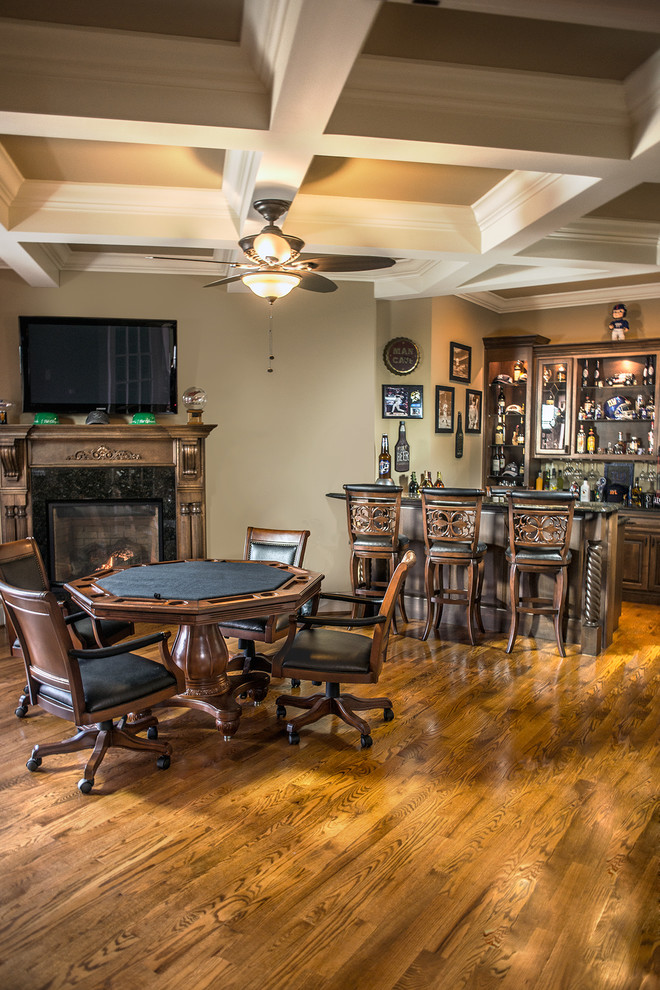 Photo of a traditional home bar in Other with medium hardwood floors and dark wood cabinets.