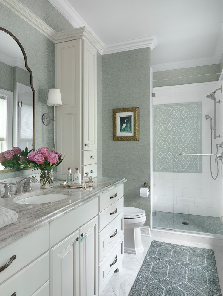 Mid-sized traditional bathroom in St Louis with raised-panel cabinets, an alcove shower, porcelain tile, green walls, porcelain floors, an undermount sink, quartzite benchtops, white floor, a hinged shower door, white cabinets and white tile.