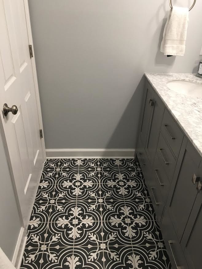 Design ideas for a mid-sized traditional 3/4 bathroom in Nashville with beaded inset cabinets, grey cabinets, an alcove tub, a shower/bathtub combo, black and white tile, ceramic tile, grey walls, ceramic floors, an undermount sink, marble benchtops, black floor and a shower curtain.