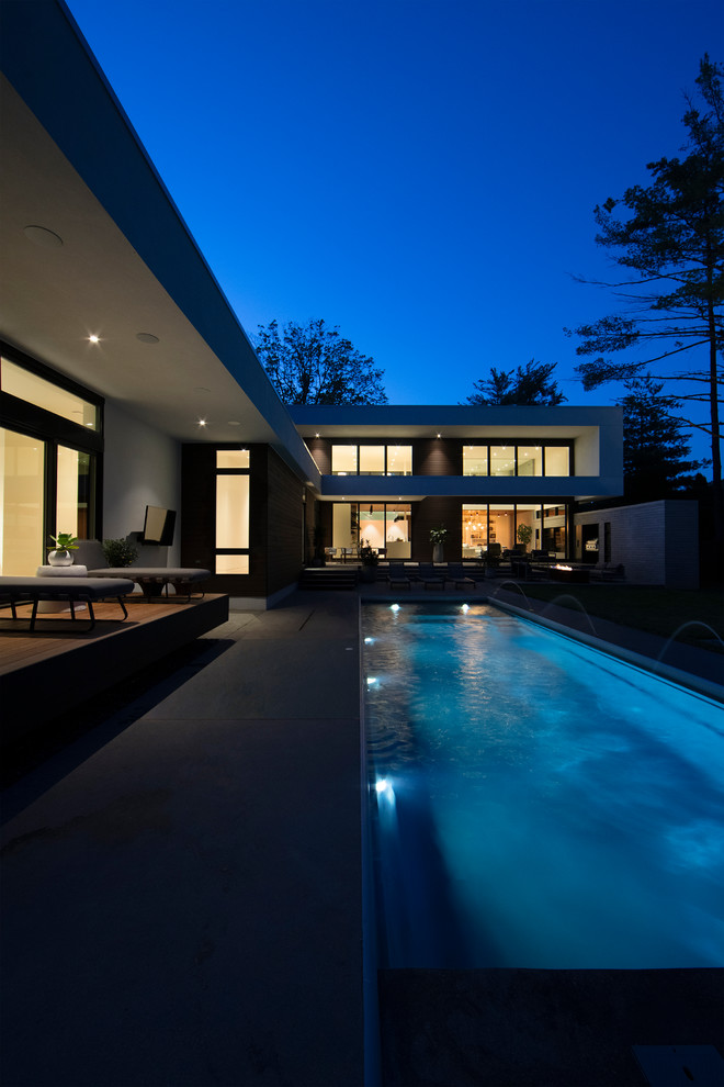 Inspiration for a modern backyard rectangular lap pool in Indianapolis with concrete slab.
