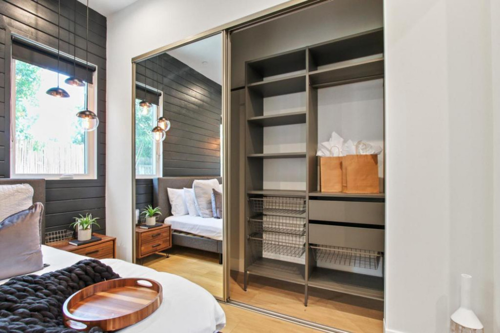 Photo of a medium sized contemporary gender neutral standard wardrobe in Dallas with open cabinets, grey cabinets, light hardwood flooring, brown floors and a wallpapered ceiling.