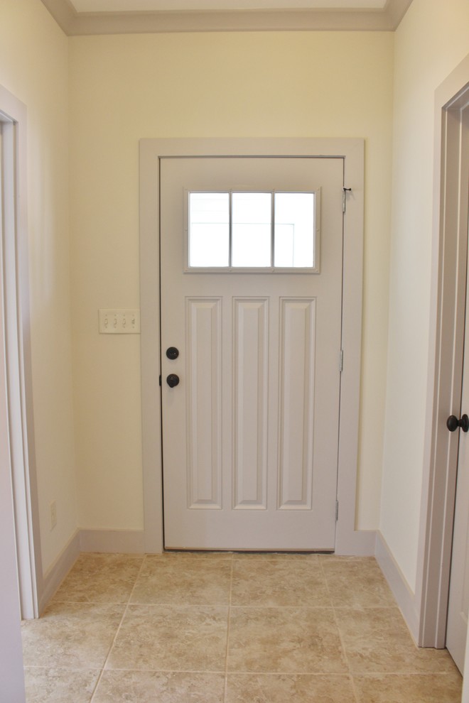 Small transitional hallway in Birmingham with beige walls and ceramic floors.
