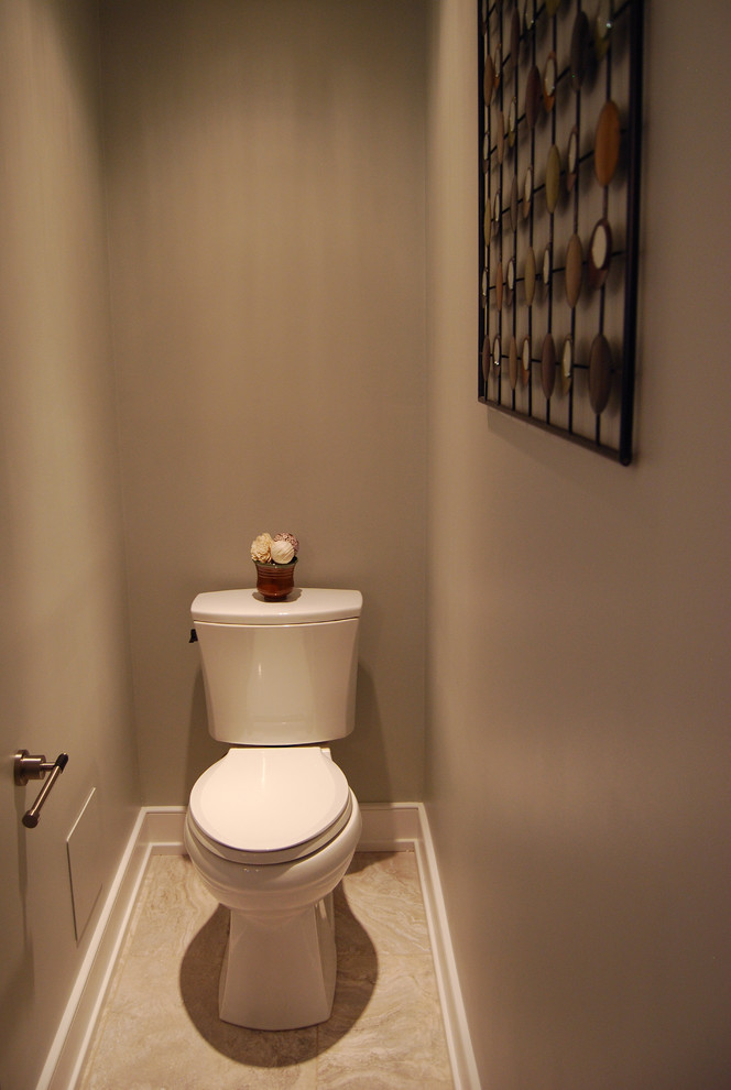 Photo of a mid-sized transitional powder room in Philadelphia with an undermount sink, recessed-panel cabinets, dark wood cabinets, granite benchtops, a two-piece toilet, beige tile, porcelain tile, grey walls and porcelain floors.