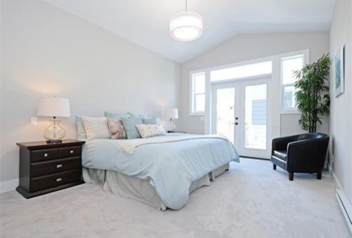 Photo of a mid-sized modern bedroom in Vancouver with grey walls, carpet and grey floor.