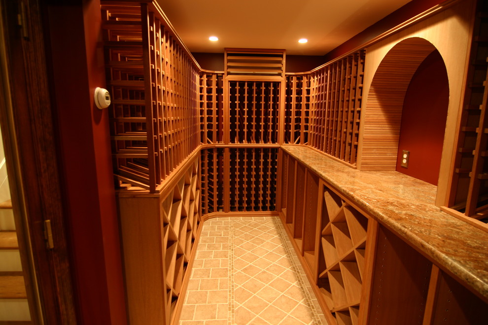 This is an example of a mid-sized country wine cellar in New York with ceramic floors and storage racks.