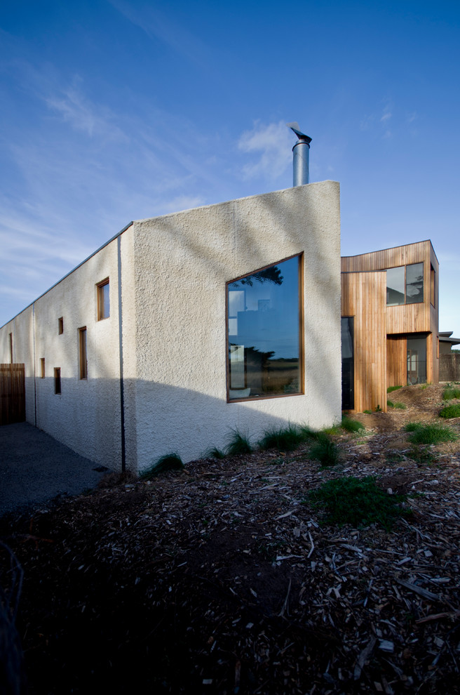 Photo of a mid-sized contemporary two-storey exterior in Geelong with mixed siding.