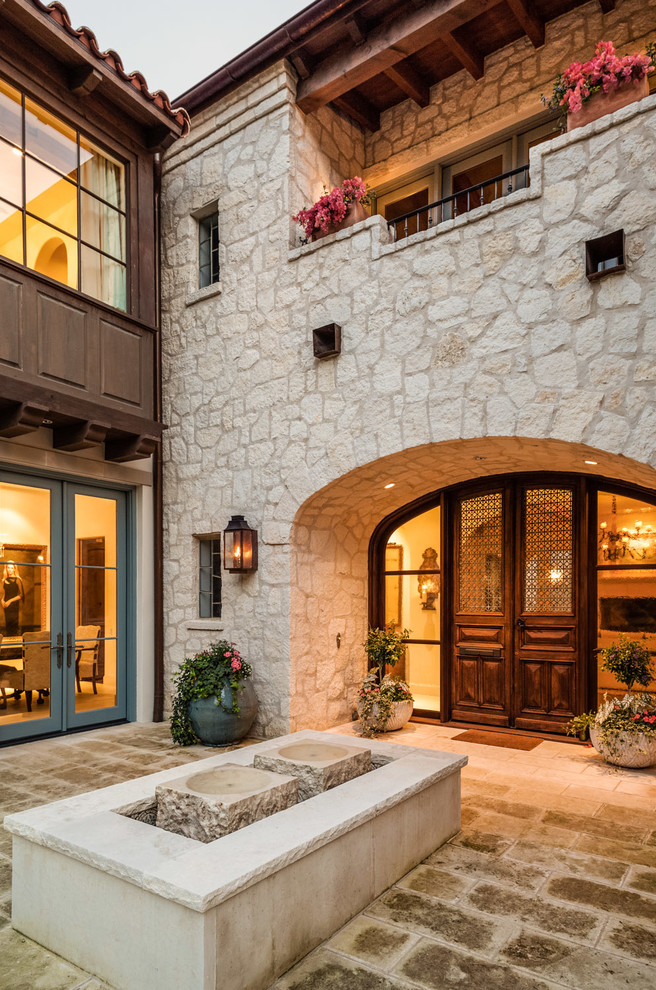 Photo of a mediterranean entryway in Other with a double front door.