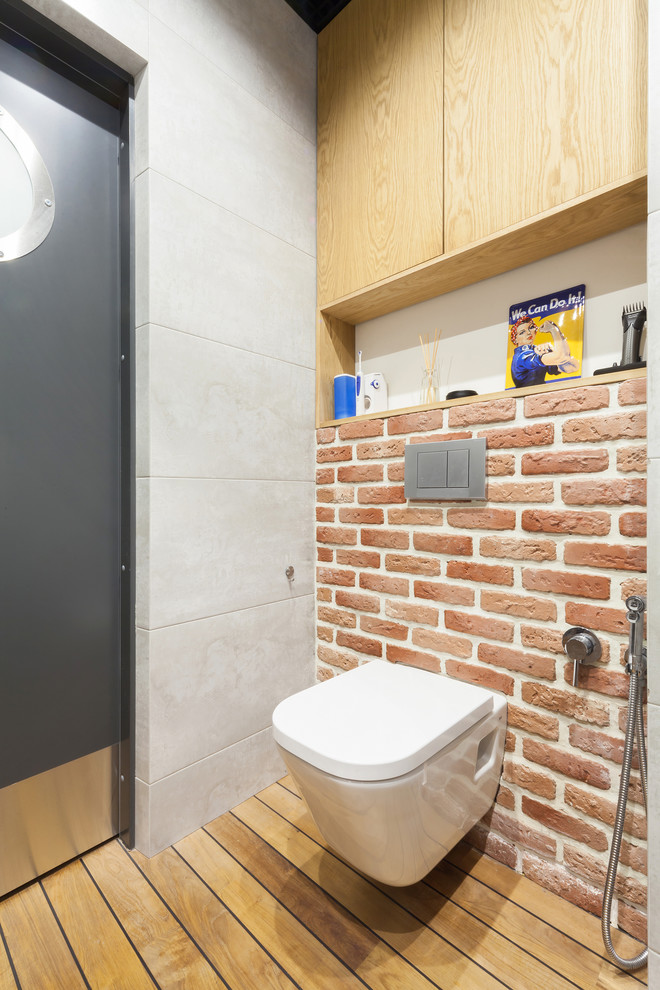 This is an example of an industrial powder room in Moscow with a wall-mount toilet.