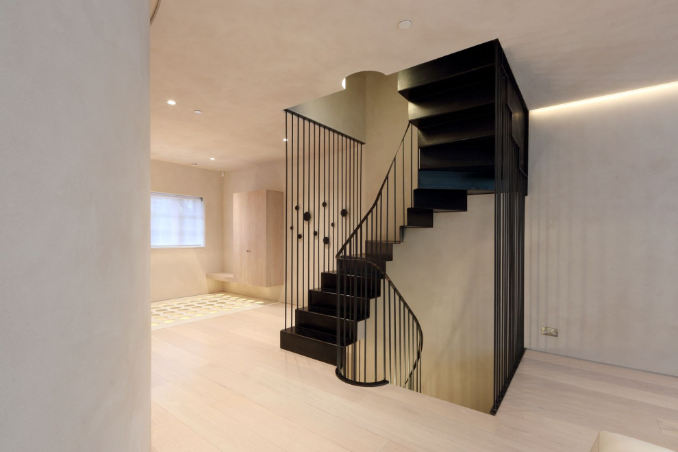 Medium sized modern metal u-shaped metal railing staircase in London with metal risers.