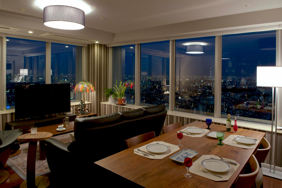 Large modern separate dining room in Tokyo Suburbs with grey walls, painted wood floors, brown floor, wallpaper and wallpaper.