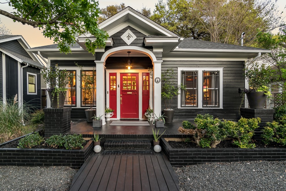 This is an example of a traditional one-storey black house exterior with wood siding.