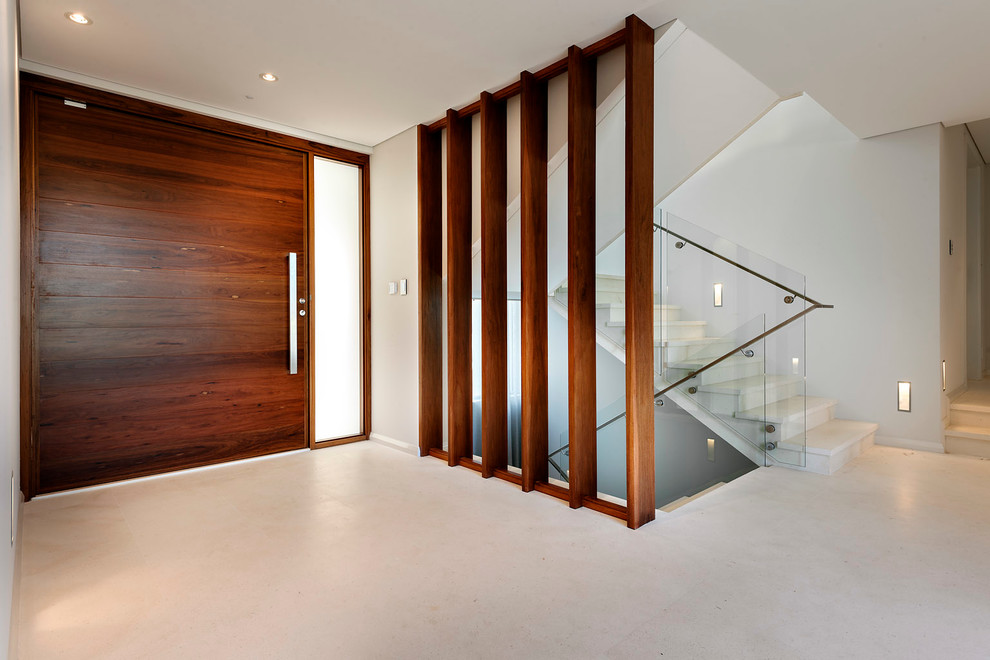 This is an example of a contemporary entryway in Perth with white walls, a pivot front door and a dark wood front door.