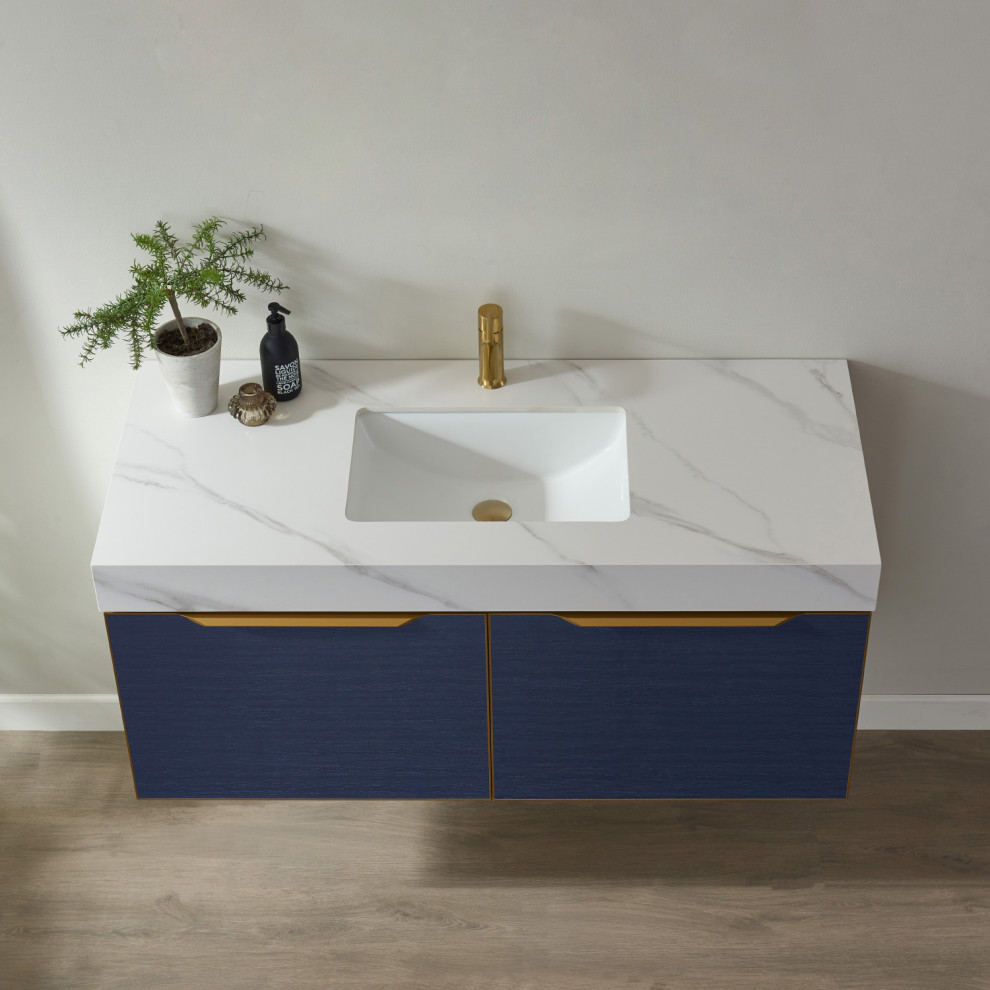 Design ideas for a medium sized modern ensuite bathroom in Manchester with flat-panel cabinets, blue cabinets, a submerged sink, engineered stone worktops, white worktops, a single sink and a floating vanity unit.