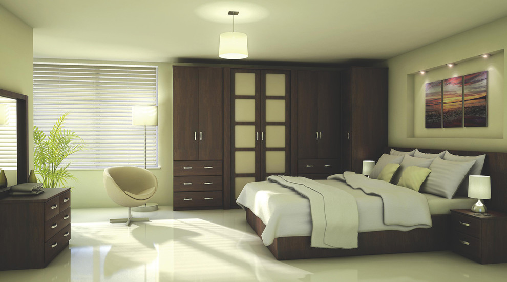 Inspiration for a large contemporary master bedroom in Hampshire with beige walls and marble floors.