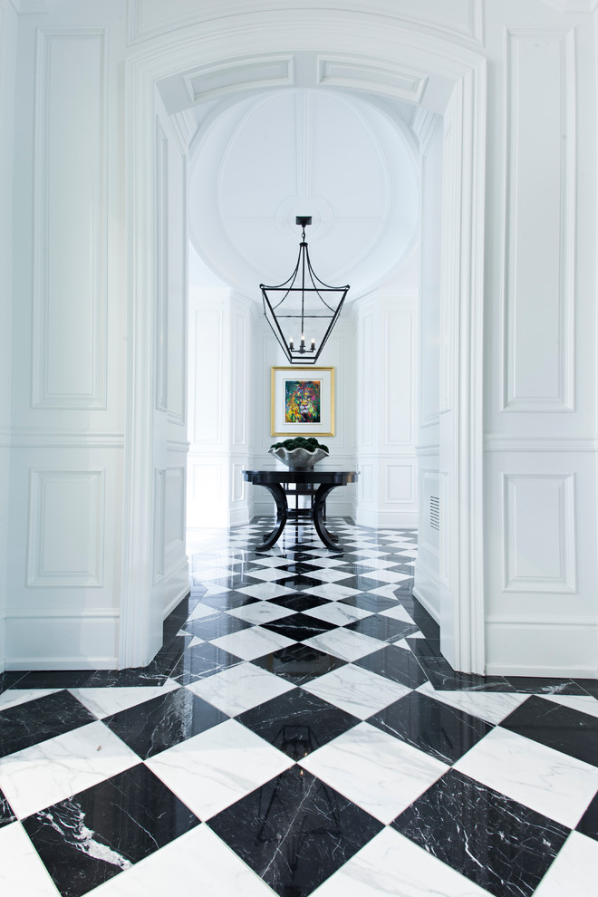 This is an example of a traditional foyer in Toronto with white walls, marble floors and multi-coloured floor.