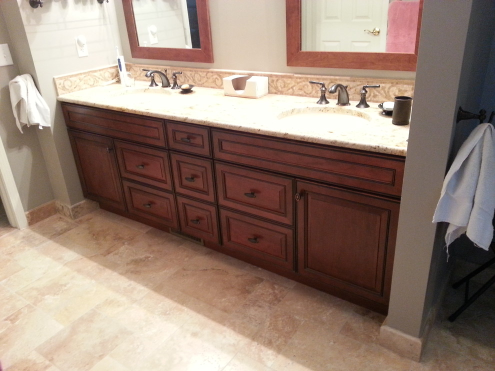 Example of a transitional master multicolored tile and porcelain tile porcelain tile home design design in Detroit with recessed-panel cabinets, medium tone wood cabinets, a two-piece toilet, green walls, an undermount sink and granite countertops