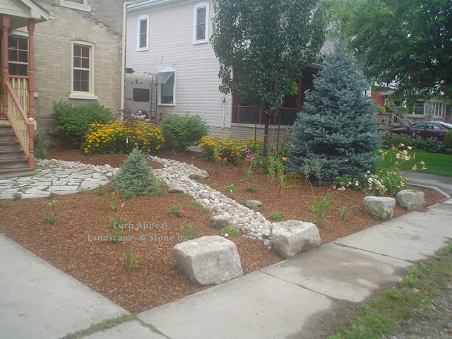 low maintenance front yard, with dry river bed to handle ...