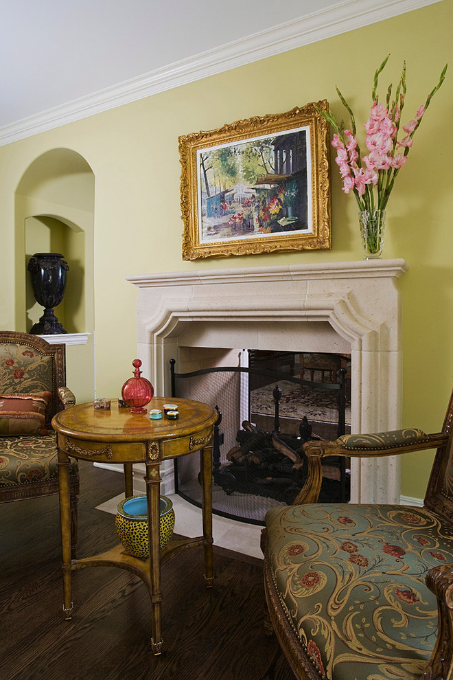 Inspiration for an expansive traditional enclosed living room in Chicago with yellow walls, dark hardwood floors, a two-sided fireplace and a stone fireplace surround.