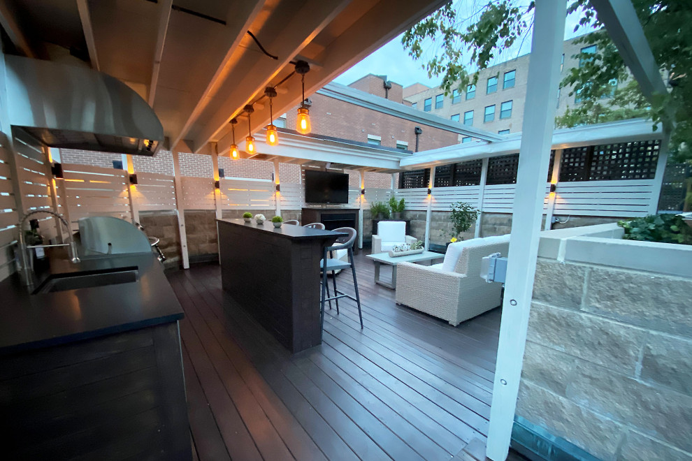 This is an example of a world-inspired back private and first floor mixed railing terrace in Chicago with a pergola.