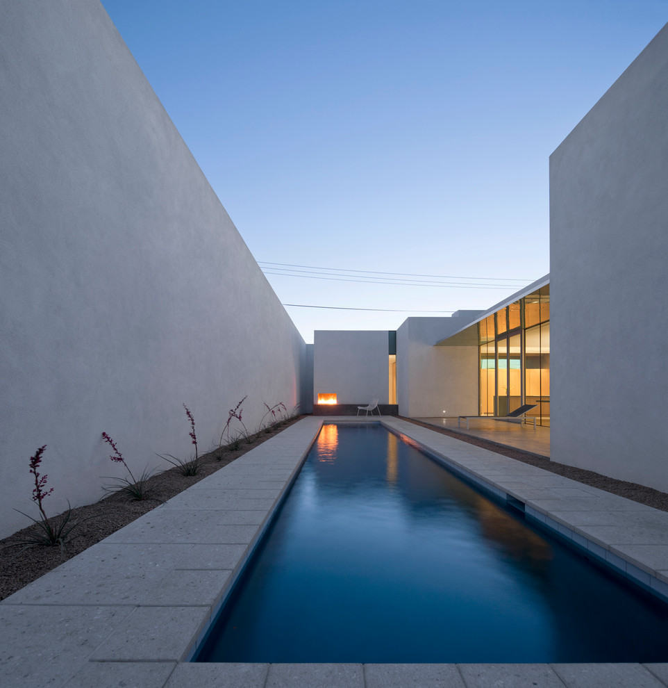 Inspiration for a small contemporary courtyard rectangular pool with concrete pavers.