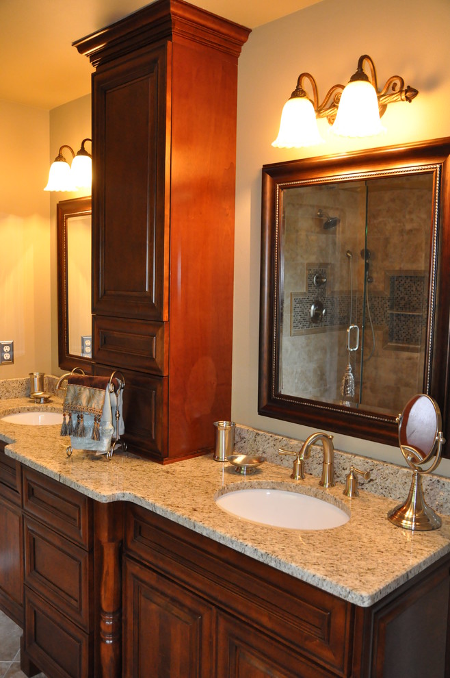 Photo of a mid-sized arts and crafts master bathroom in Atlanta with raised-panel cabinets, medium wood cabinets, a claw-foot tub, an open shower, a two-piece toilet, beige tile, stone tile, beige walls, travertine floors, an undermount sink and granite benchtops.