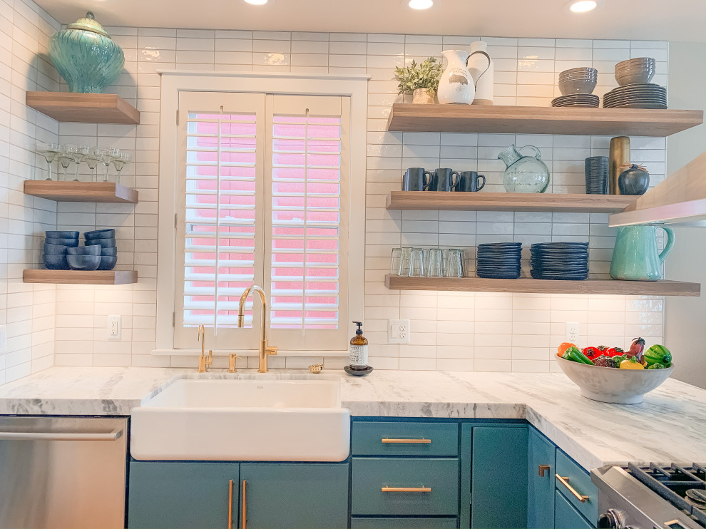 Inspiration for a mid-sized transitional u-shaped medium tone wood floor open concept kitchen remodel in Denver with a farmhouse sink, flat-panel cabinets, turquoise cabinets, quartzite countertops, white backsplash, ceramic backsplash, stainless steel appliances and white countertops