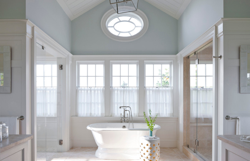 Photo of a large traditional master bathroom in Boston with beaded inset cabinets, white cabinets, a freestanding tub, a curbless shower, a one-piece toilet, beige tile, ceramic tile, blue walls, mosaic tile floors, an undermount sink and marble benchtops.