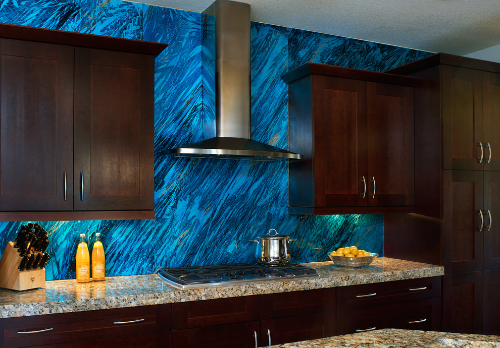 Transitional kitchen photo in Denver with blue backsplash, glass sheet backsplash and stainless steel appliances