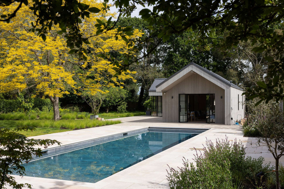 Design ideas for a coastal Rectangular swimming pool in Hertfordshire With Tile.