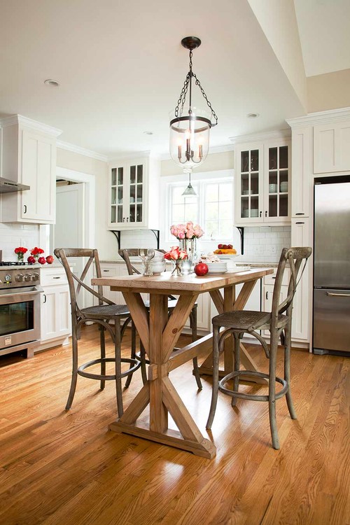 Small kitchen with a pub table and three stools