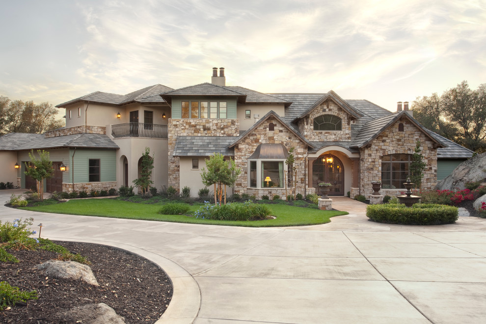 Design ideas for a two-storey beige exterior in Sacramento with stone veneer and a flat roof.