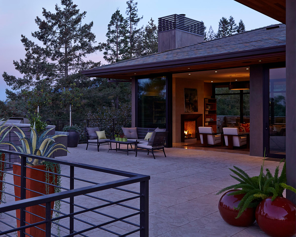 Deck - large modern side yard stone deck idea in San Francisco with a roof extension