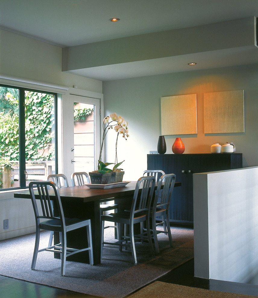 This is an example of a contemporary dining room in San Francisco with grey walls and dark hardwood floors.