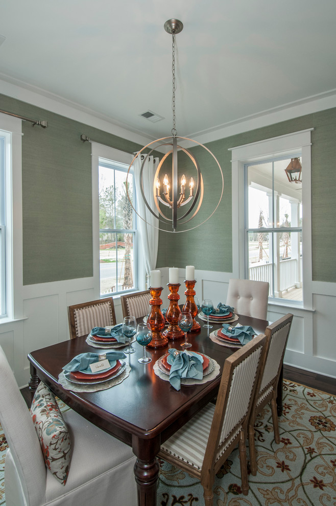 Photo of a traditional dining room in Charleston with green walls and dark hardwood floors.