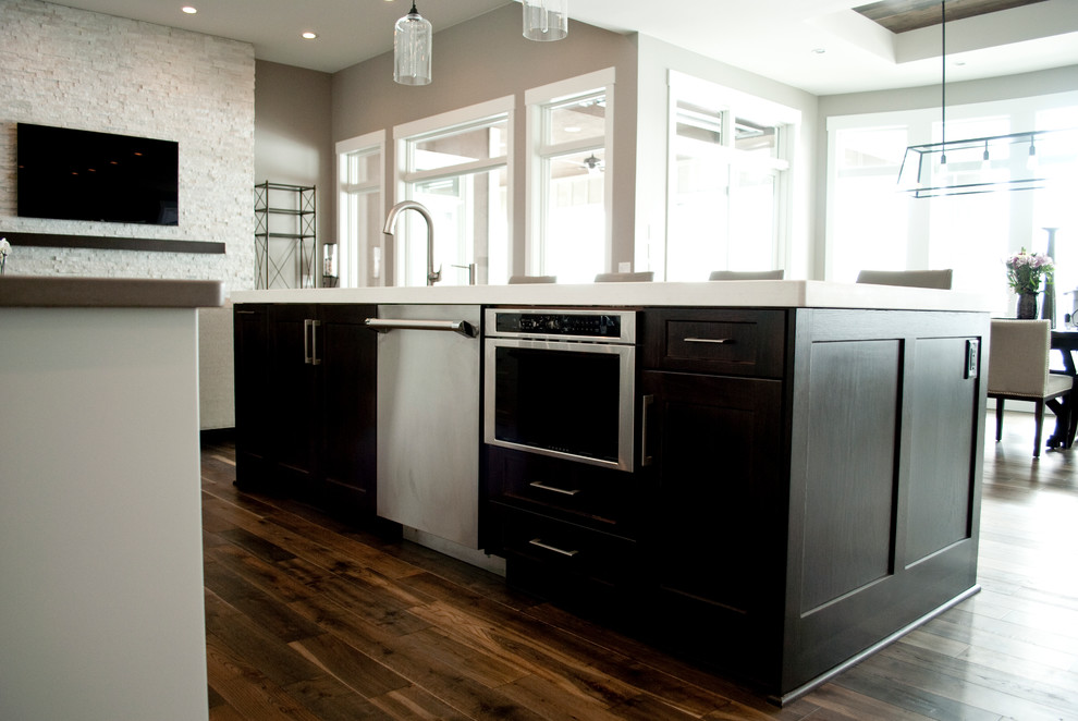 Kitchen - transitional kitchen idea with recessed-panel cabinets, white cabinets, quartz countertops, white backsplash, stainless steel appliances and an island