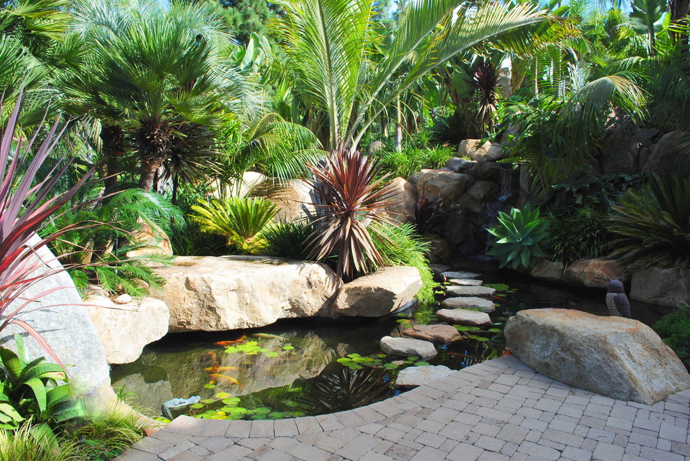 Photo of a contemporary garden in San Diego with brick pavers and with pond.