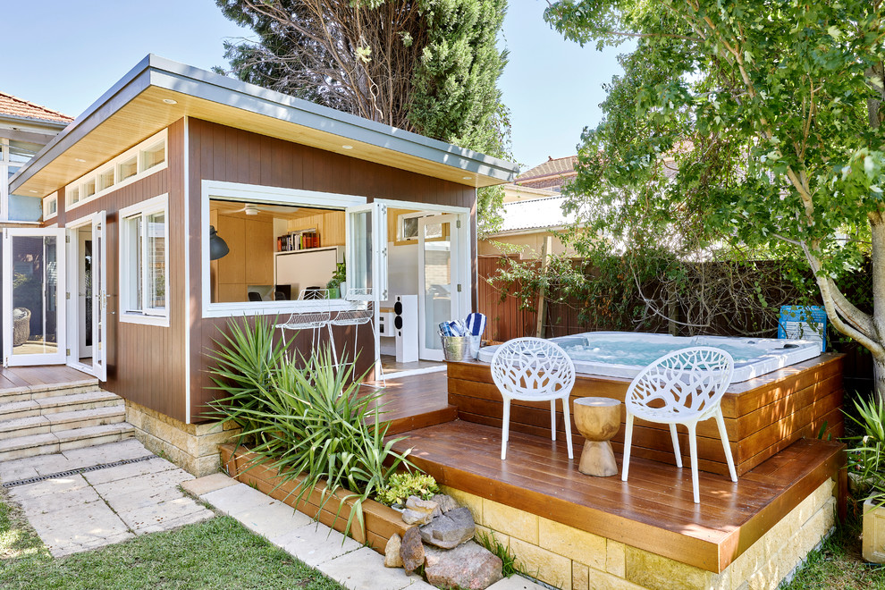 This is an example of a small contemporary side yard deck in Sydney with a container garden and no cover.