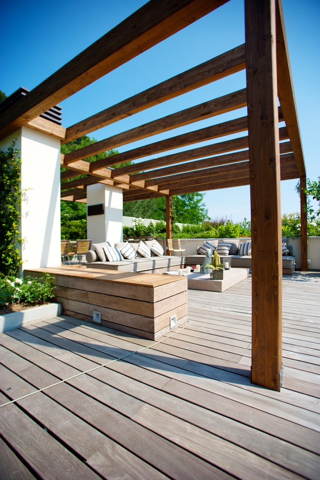 Photo of a mid-sized contemporary patio in Bologna with decking and a gazebo/cabana.