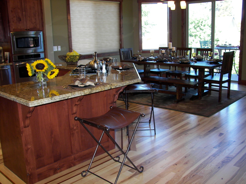Inspiration for a large rustic l-shaped medium tone wood floor open concept kitchen remodel with a drop-in sink, shaker cabinets, medium tone wood cabinets, granite countertops, green backsplash, ceramic backsplash, stainless steel appliances, green walls and an island