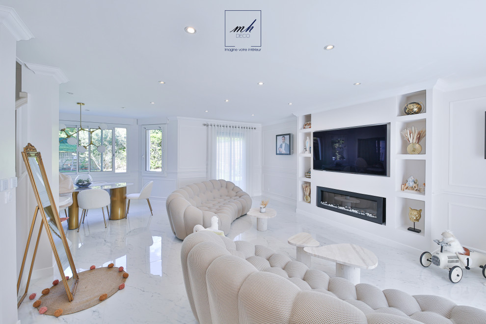 Large open concept family room in Paris with white walls, marble floors, a built-in media wall and white floor.