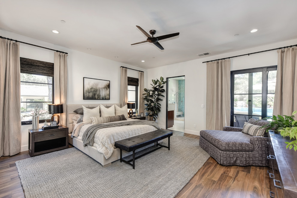 Photo of a contemporary master bedroom in Sacramento with white walls, dark hardwood floors and brown floor.