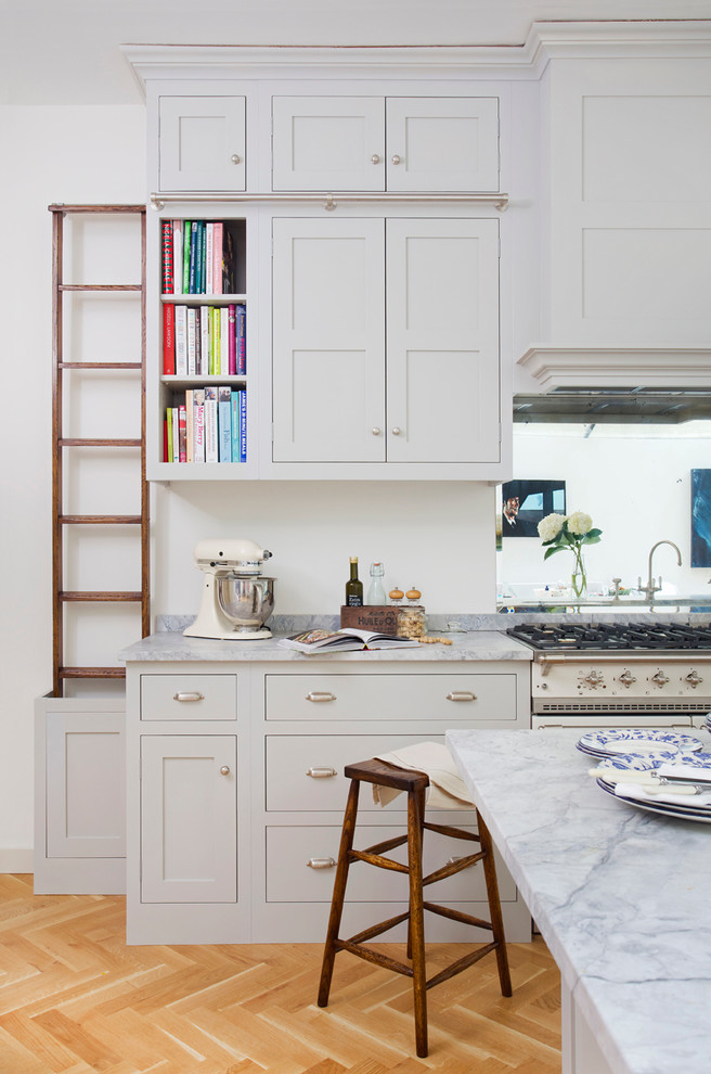 Photo of a traditional kitchen in Surrey with shaker cabinets and with island.