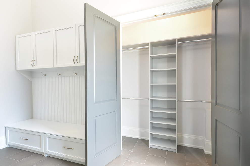This is an example of a modern mudroom in Orange County with beige walls, porcelain floors and grey floor.
