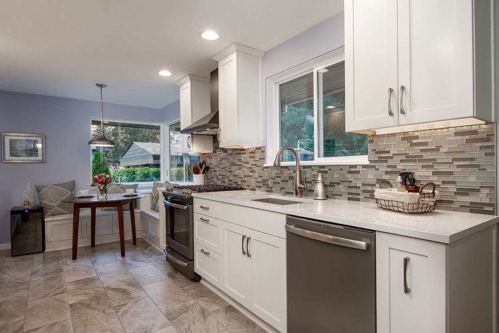 Eat-in kitchen - transitional porcelain tile and multicolored floor eat-in kitchen idea in Seattle with an undermount sink, shaker cabinets, white cabinets, quartz countertops, multicolored backsplash, glass tile backsplash, no island and white countertops