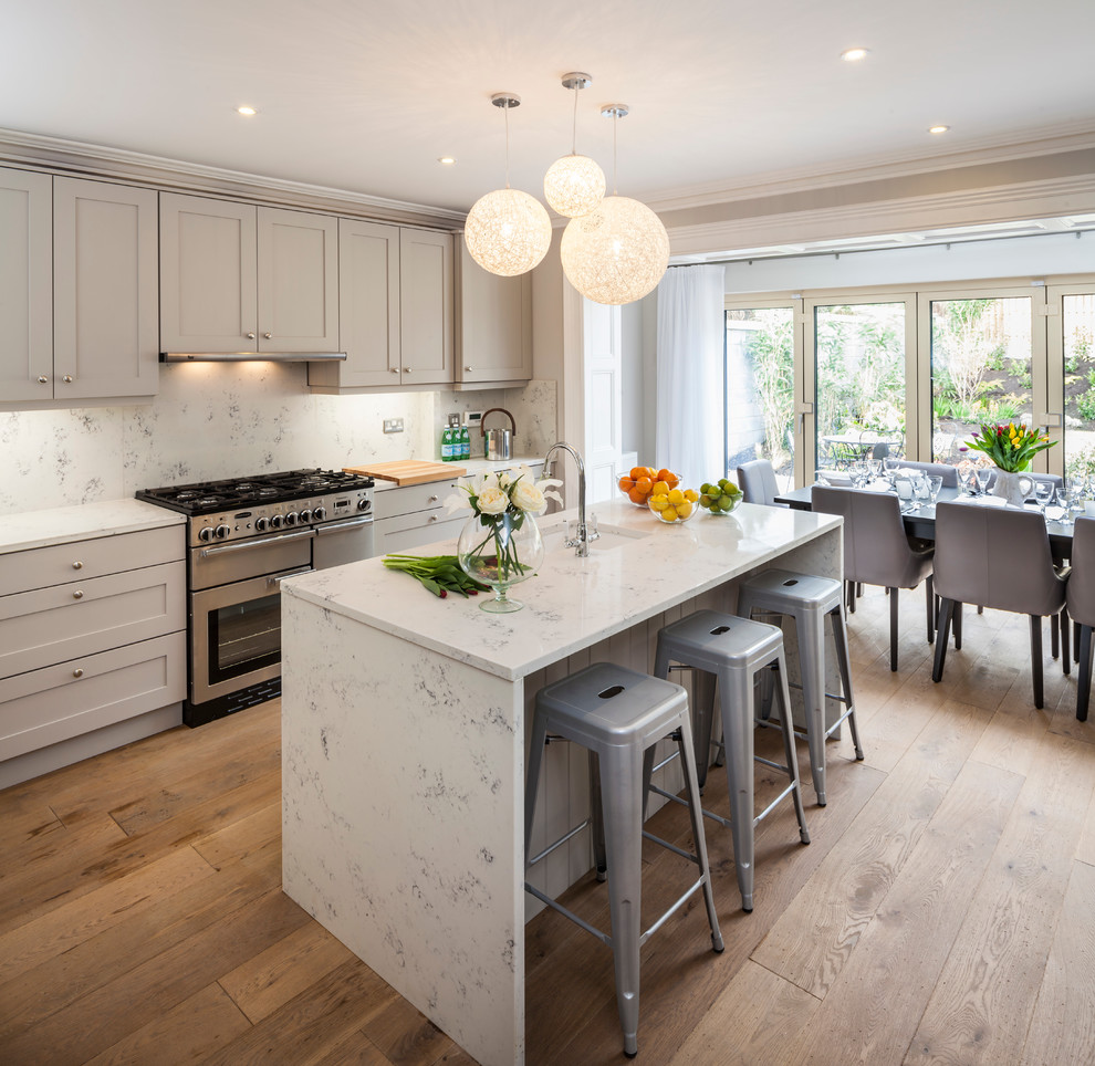 Inspiration for a transitional kitchen remodel in Dublin with recessed-panel cabinets, gray cabinets and marble countertops